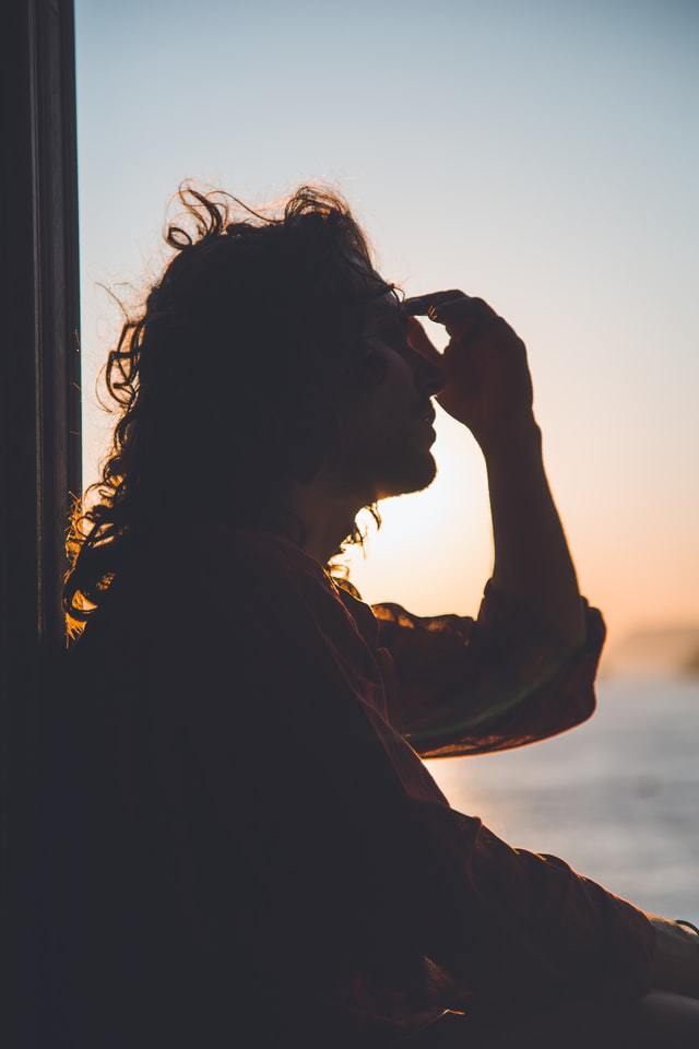 Silhouette of woman with hand on her face | What do I want to do before I retire