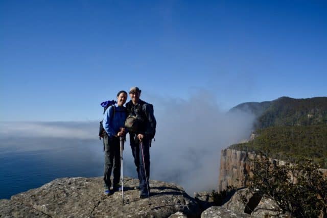 Jay & Sara on top of cliffs overlooking sea