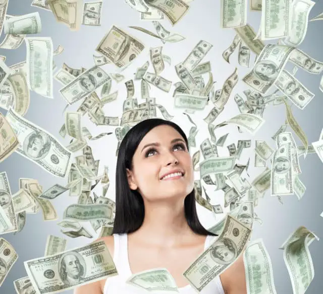 A Portrait of a dreamy brunette lady in a white tank top. Dollar notes are falling from the ceiling.