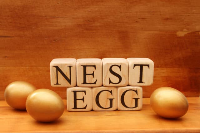Building blocks spell out nest egg plus 3 eggs next to buildng blocks